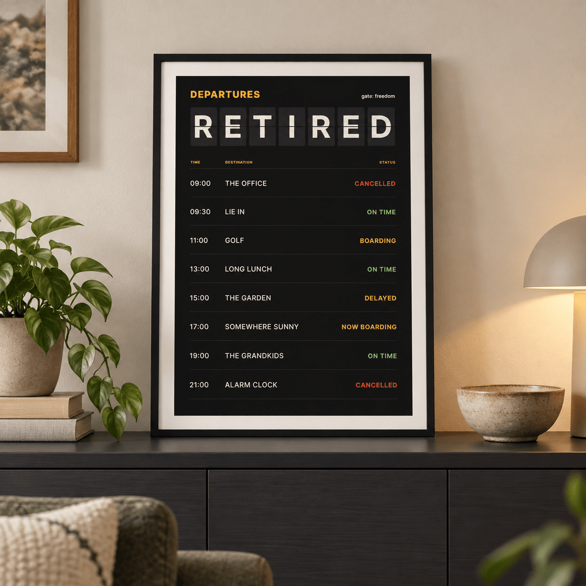 Departures board retirement print above a sofa in a relaxed living room