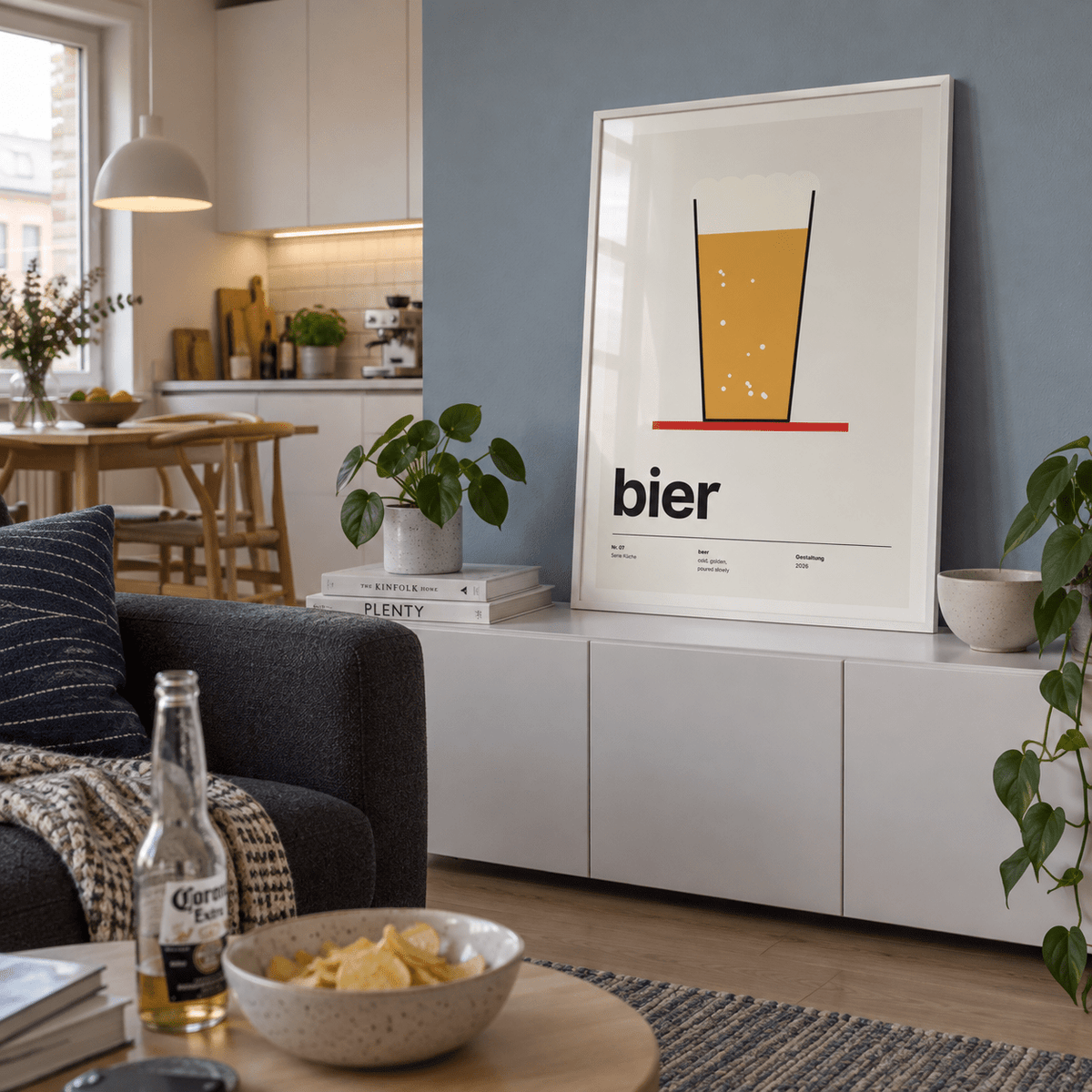 Pint of beer on a red coaster print above a sideboard in a kitchen adjacent