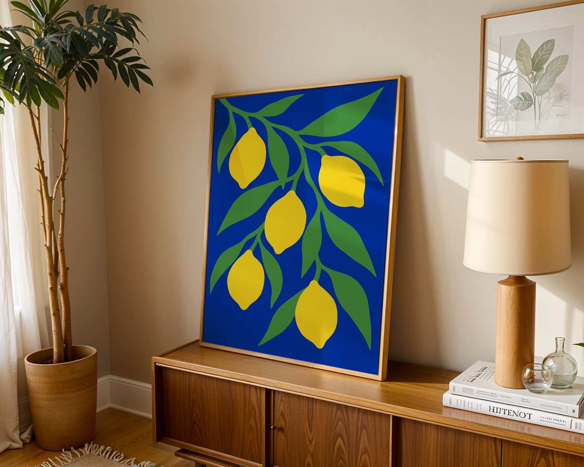 Lemon tree print on deep blue leaning on a wooden sideboard in a warm living room