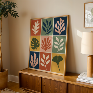 Cut out print of nine leaf tiles leaning on a wooden sideboard in a warm living room