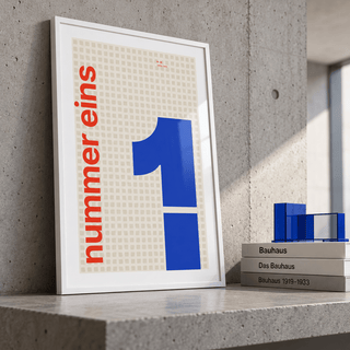 Giant cobalt number 1 print leaning on a picture ledge