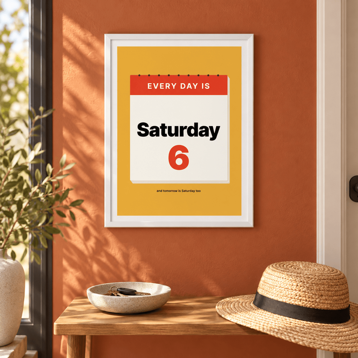 Every day is Saturday print above a console in an entrance hall