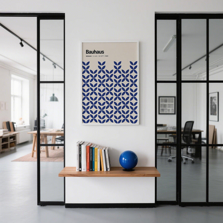 Simple Wall Art framed print with blue geometric pattern and black text above a shelf with books and a blue ball