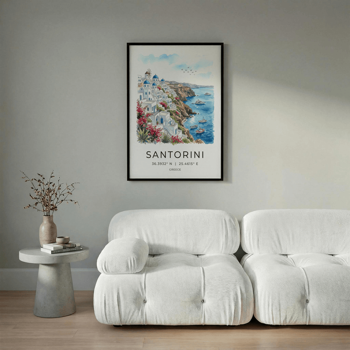 Santorini art print of a watercolour cliffside village above a white sofa with a side table and vase