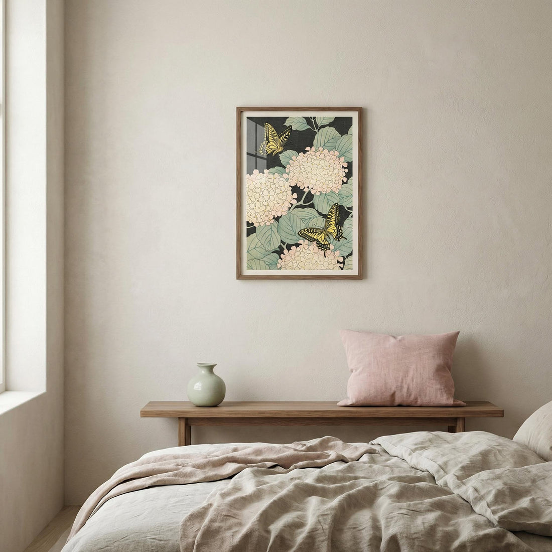 Japanese-style print of cream hydrangeas and yellow butterflies on a dark background above a bed with linen bedding