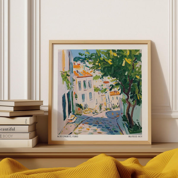French Artwork Prints of a cobbled Montmartre street lined with white buildings.
