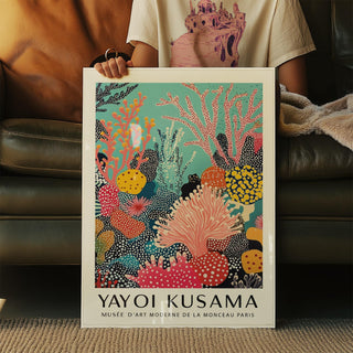 Bold bright wall art with red, orange, and yellow coral against a blue sea