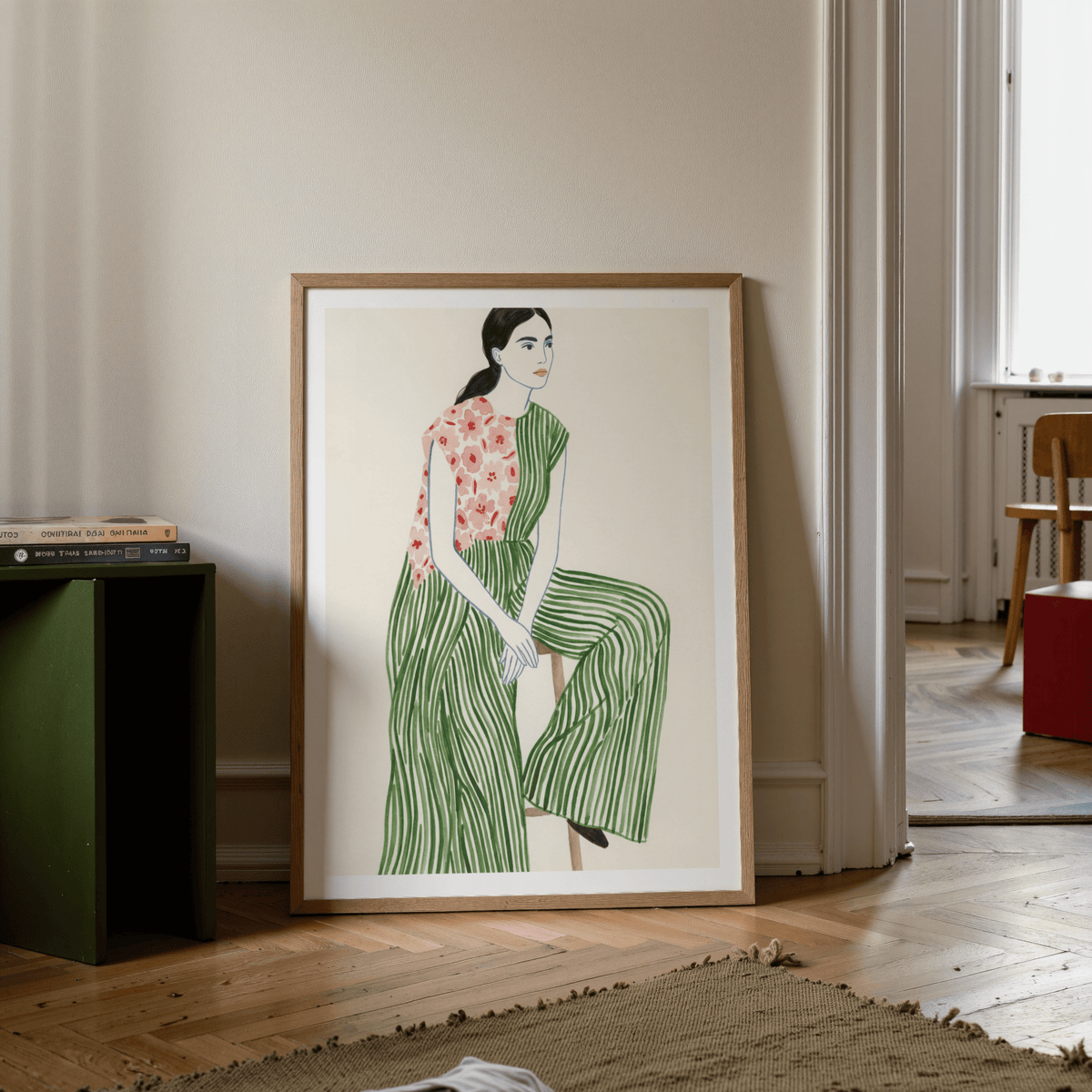 Framed artwork of a woman in a green dress with a floral top in a room.