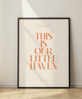 Framed poster with 'This is our little haven' text on a wall.