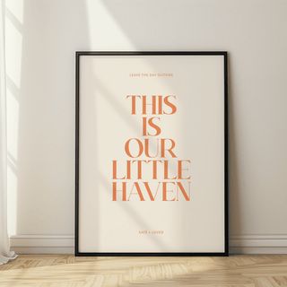 Framed poster with 'This is our little haven' text on a wall.
