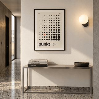 Black dots growing in size print above a console table in a hallway