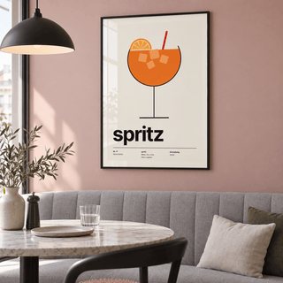 Spritz with ice and orange wheel print above a banquette in a dining