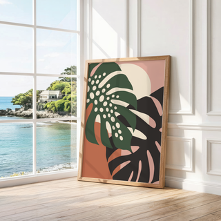 Dark green leaf with cream holes leaning by a bright window with a sea view