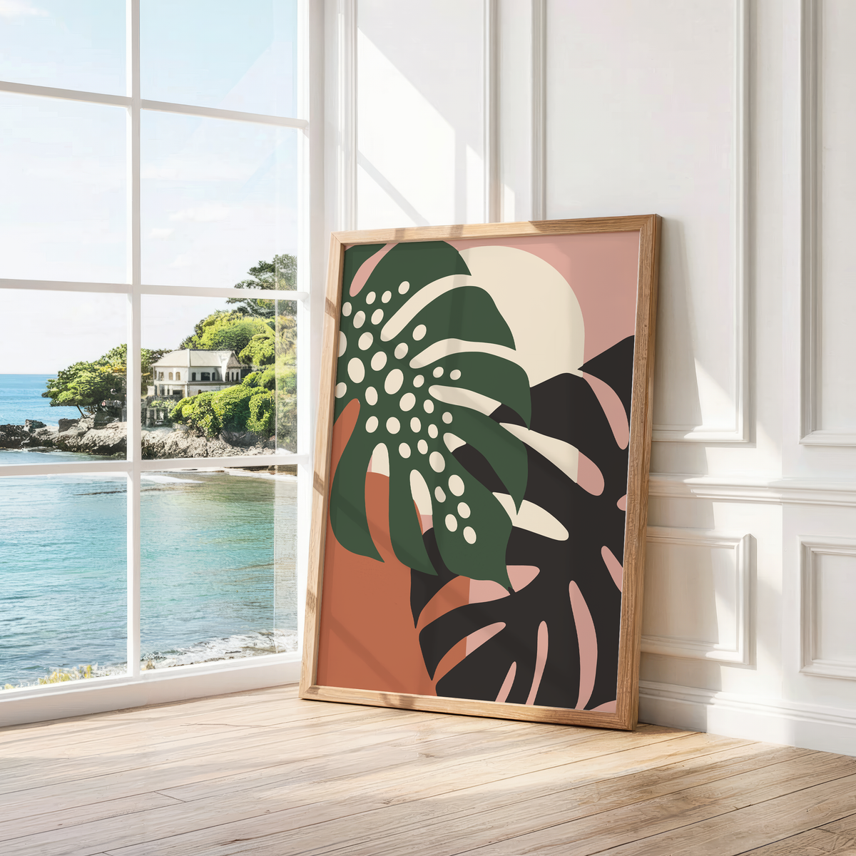 Dark green leaf with cream holes leaning by a bright window with a sea view