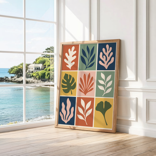 Grid of colourful leaf shapes leaning by a bright window with a sea view