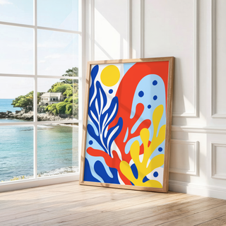 Cobalt, red and yellow sea shapes leaning by a bright window with a sea view