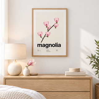 Bare branch with pink magnolia blooms above a dresser in a calm bedroom