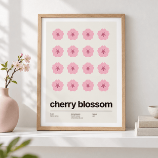 Sixteen pink cherry blossoms in a grid leaning on a shelf with ceramics