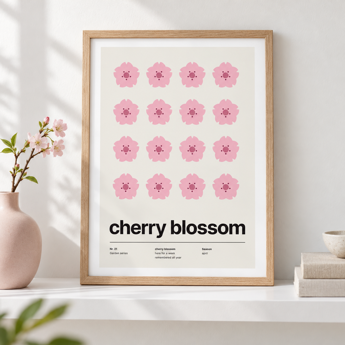 Sixteen pink cherry blossoms in a grid leaning on a shelf with ceramics