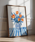 Tulip Wall Art with orange tulips in a blue striped vase on a patterned table.