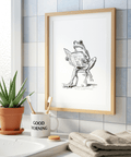 Frog Reading Art Print showing a frog reading while seated on a toilet