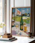 Plein-air style print of golf course view with railing, flag 19, and drinks arranged on a patio table