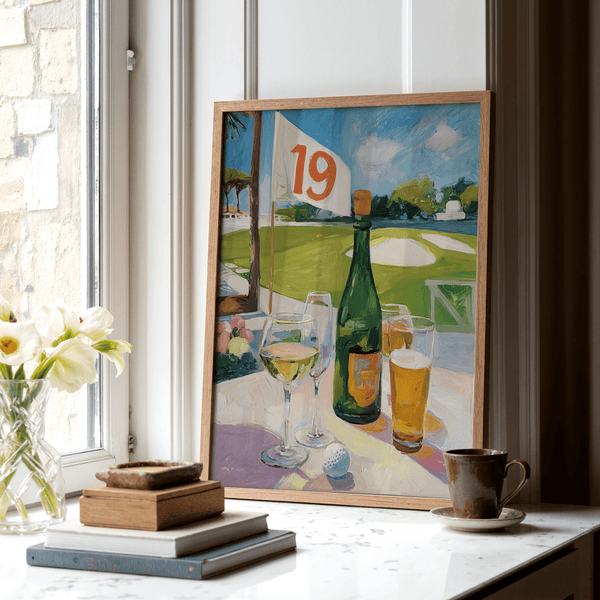 Plein-air style print of golf course view with railing, flag 19, and drinks arranged on a patio table