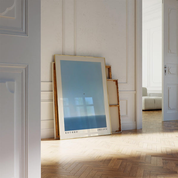 Minimalist blue wall art featuring a bird and gentle seascape.