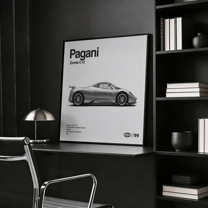 Italian Supercar wall art leaning on a desk with a metal lamp nearby in a dark room