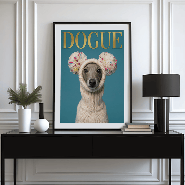 Fashion Dog Poster print of a grey dog in a white knit hat with pom poms on a blue background on a black sideboard with a lamp
