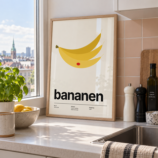 Swiss style banana typography print in a kitchen window against a peach wall