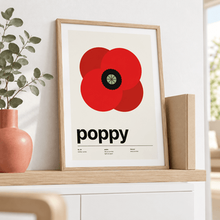 Swiss style poppy print leaning on a sideboard beside a pink vase