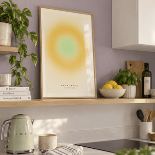 Warm yellow gradient print on a shelf in a kitchen against a lavender wall