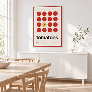 One yellow tomato among red ones above a wooden sideboard in a dining room