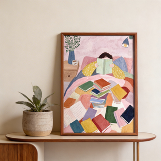 Cozy reading scene print featuring a bedside table, vase of leaves, and mug