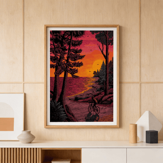 Sunset lakeshore scene wall art print showing a cyclist on a winding road and birds in the sky