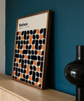 Detailed close-up of black and orange shapes in Bauhaus pattern print.