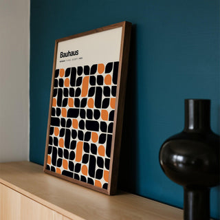 Detailed close-up of black and orange shapes in Bauhaus pattern print.