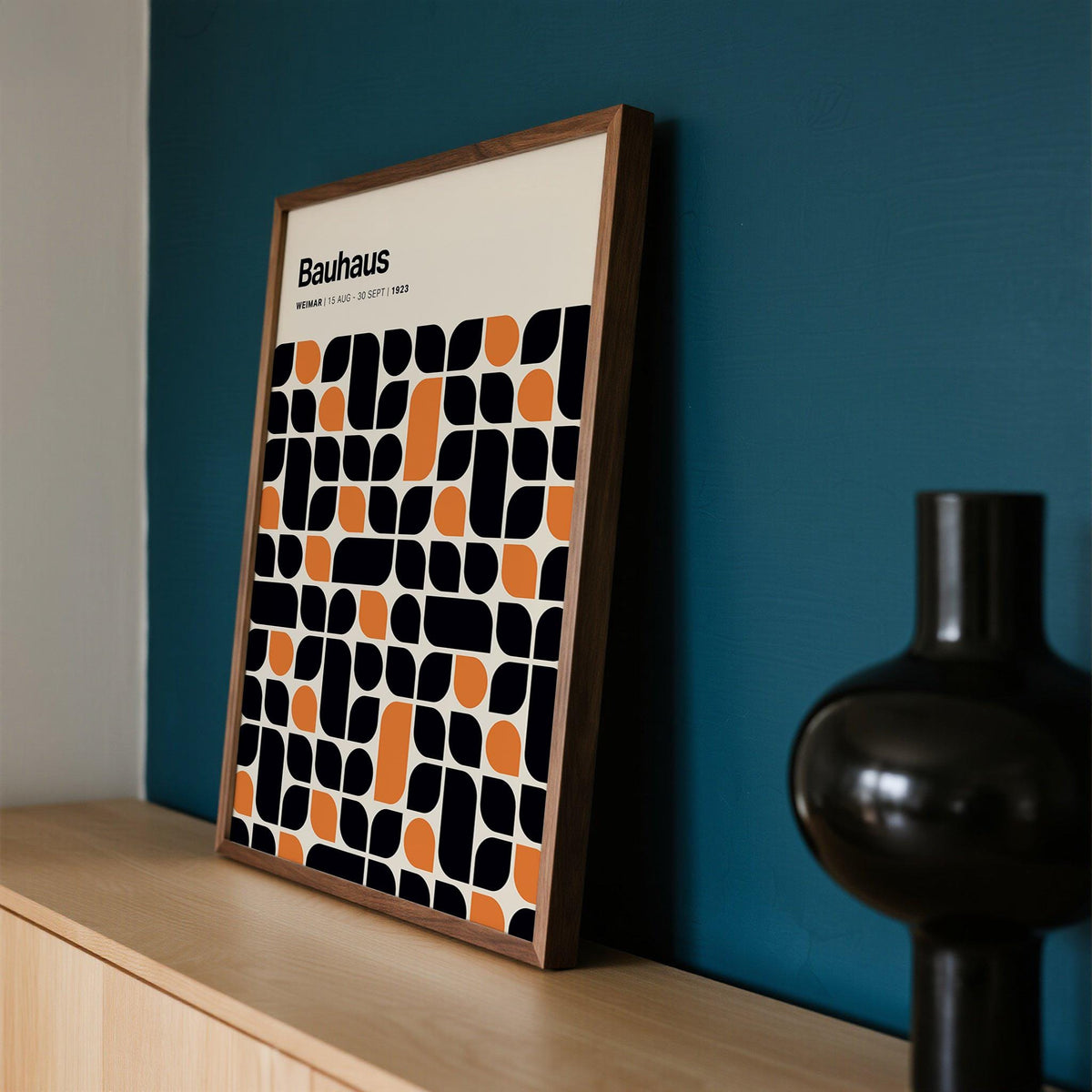 Detailed close-up of black and orange shapes in Bauhaus pattern print.