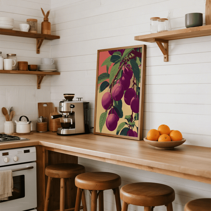 Plum Poster print leaning on a kitchen counter with a bowl of oranges nearby
