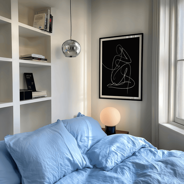 Line drawing poster highlighting curved arms, torso, and bent knees