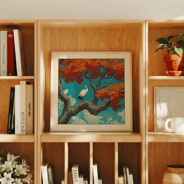 Hasui Kawase Crane Print leaning on a wooden shelf surrounded by books and a potted plant