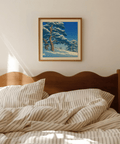 Landscape wall art print of winter pines with twisting trunks and speckled snowfall