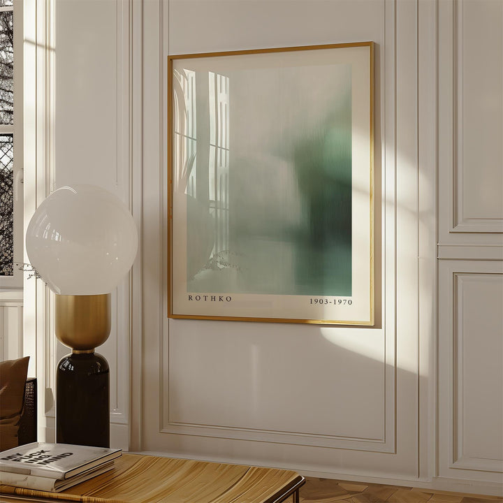 Rothko print with soft green and blue abstract colour fields in a white framed wall scene with a tall lamp and books