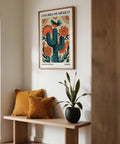 Cactus wall art showing blooming flowers and a songbird in a rustic scene.