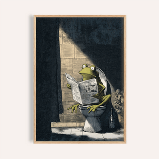 Framed print of funny frog art print with green frog reading newspaper on toilet in dark bathroom