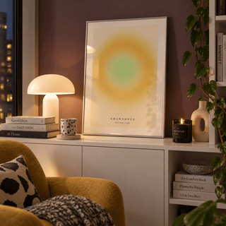 Golden yellow aura print in a reading corner against a plum wall
