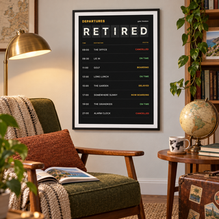 Departures board retirement print above an armchair in a cosy reading corner