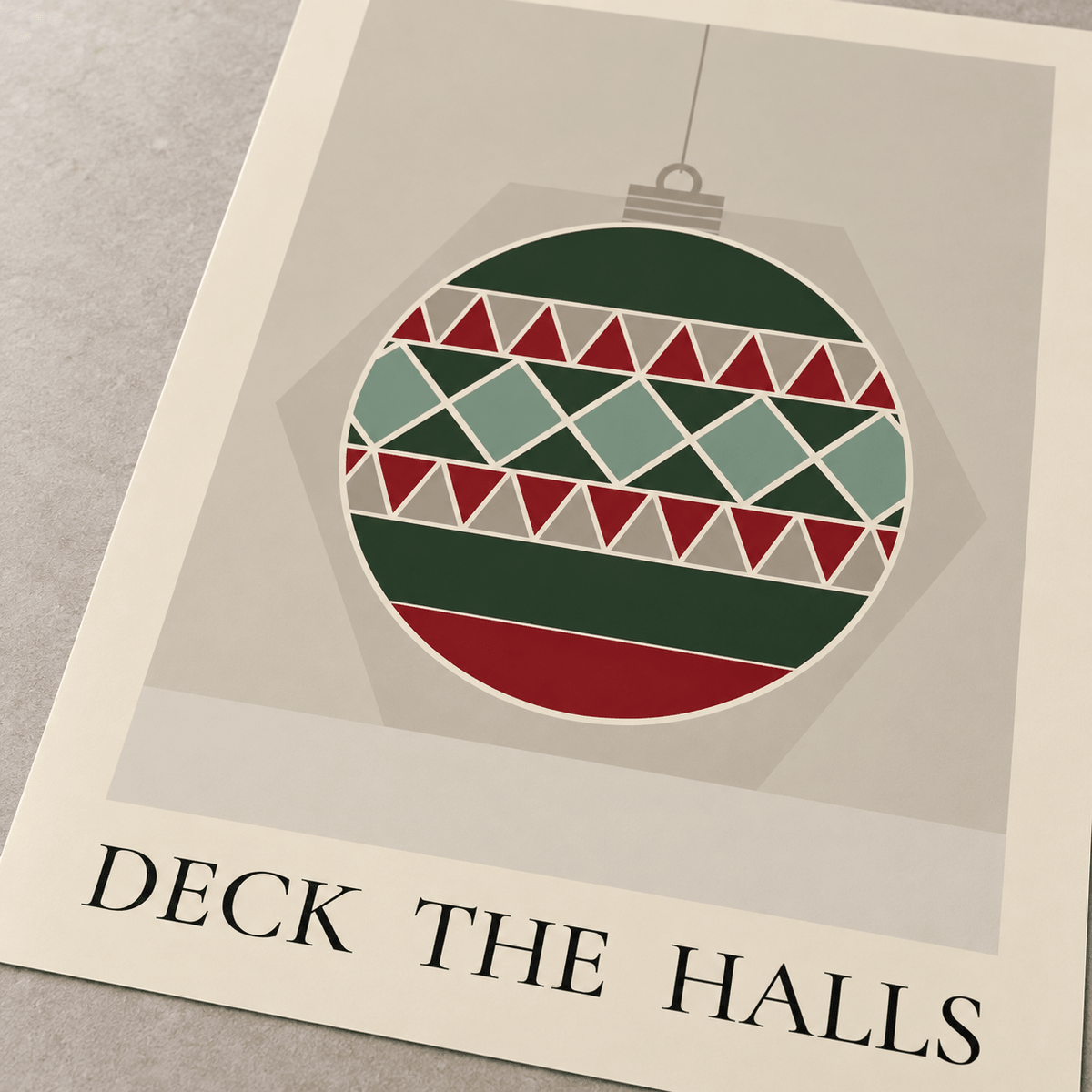 Close view of the patchwork Christmas bauble print showing the paper texture and lettering