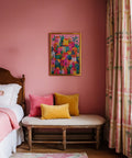 Boho decor featuring a Mexican Village Painting with pink, yellow, and teal houses.